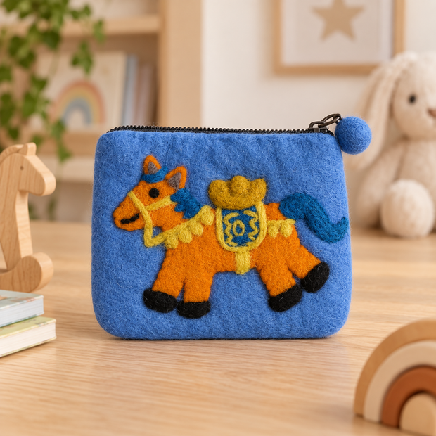Blue cowboy horse felt coin purse in a warm nursery setting