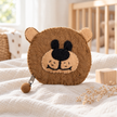 Felt brown bear coin purse in a warm nursery setting