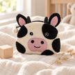 Felt cow coin purse in a warm nursery setting