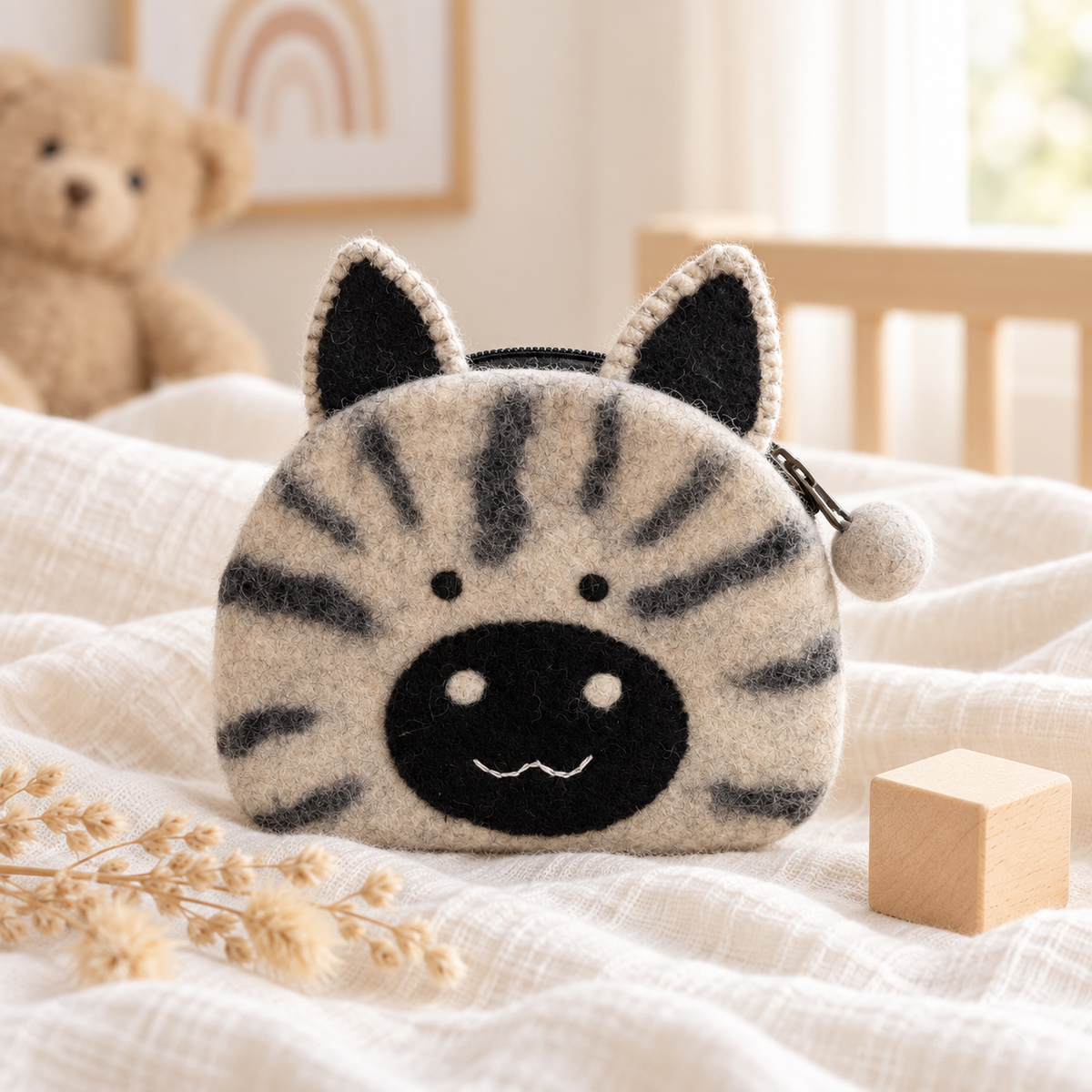 Felt tabby cat coin purse in a warm nursery setting