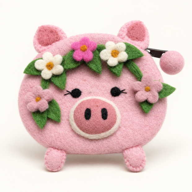 Pink felt pig coin purse with handmade floral details, front view