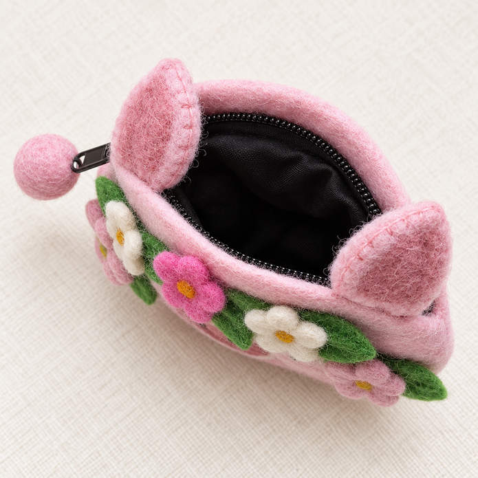 Open pink felt pig coin purse showing black zip and lining